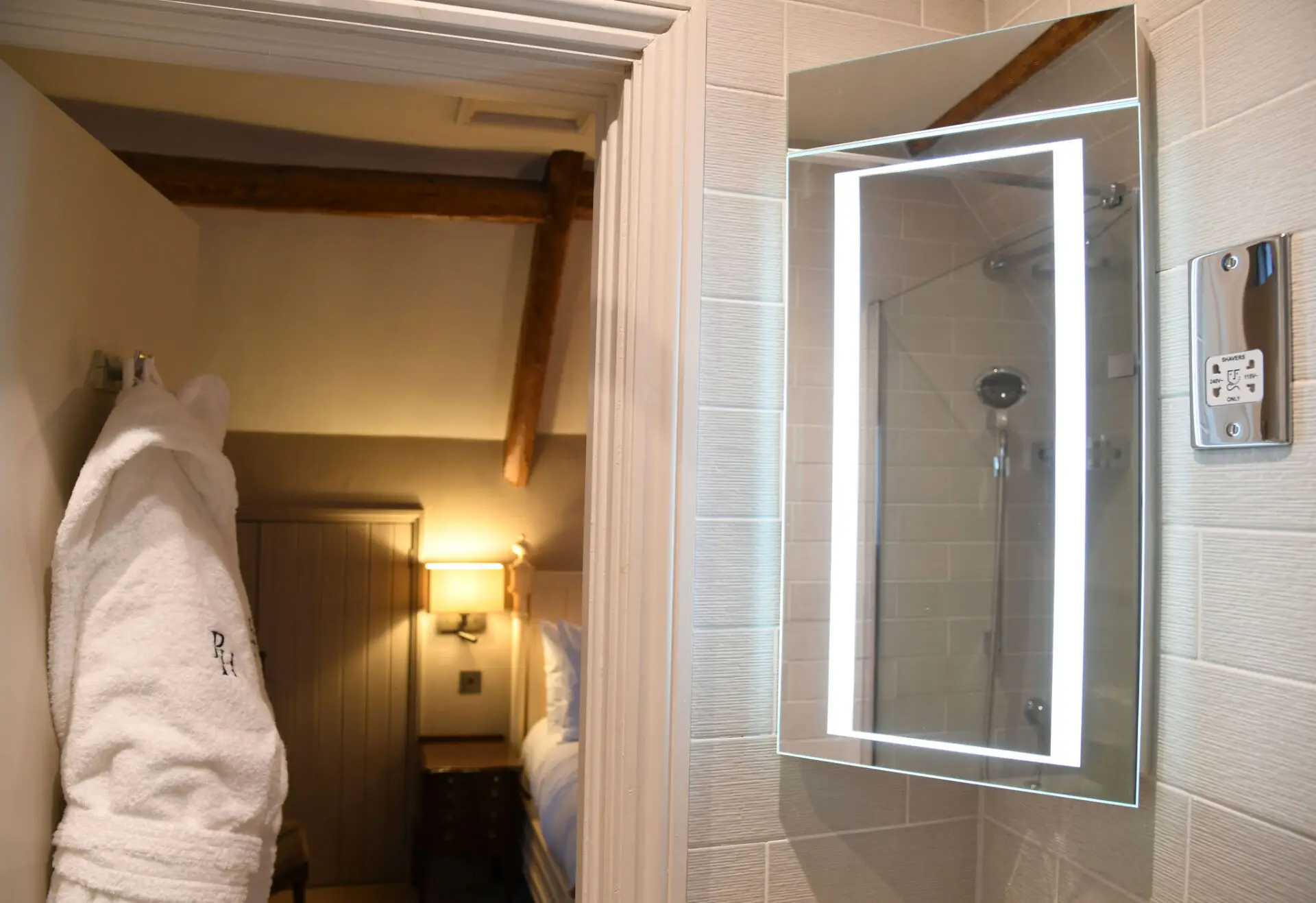 hotel bathroom looking back into the room