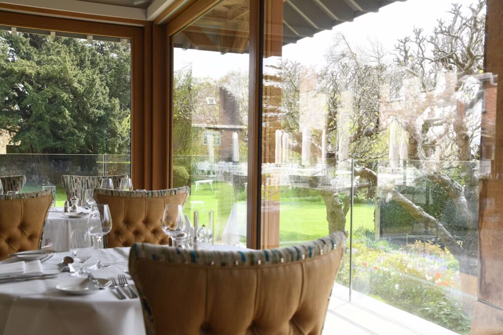 The Garden Room Restaurant at Priory Wareham - The view from the reasturant overlooking the lawn towards the hotel